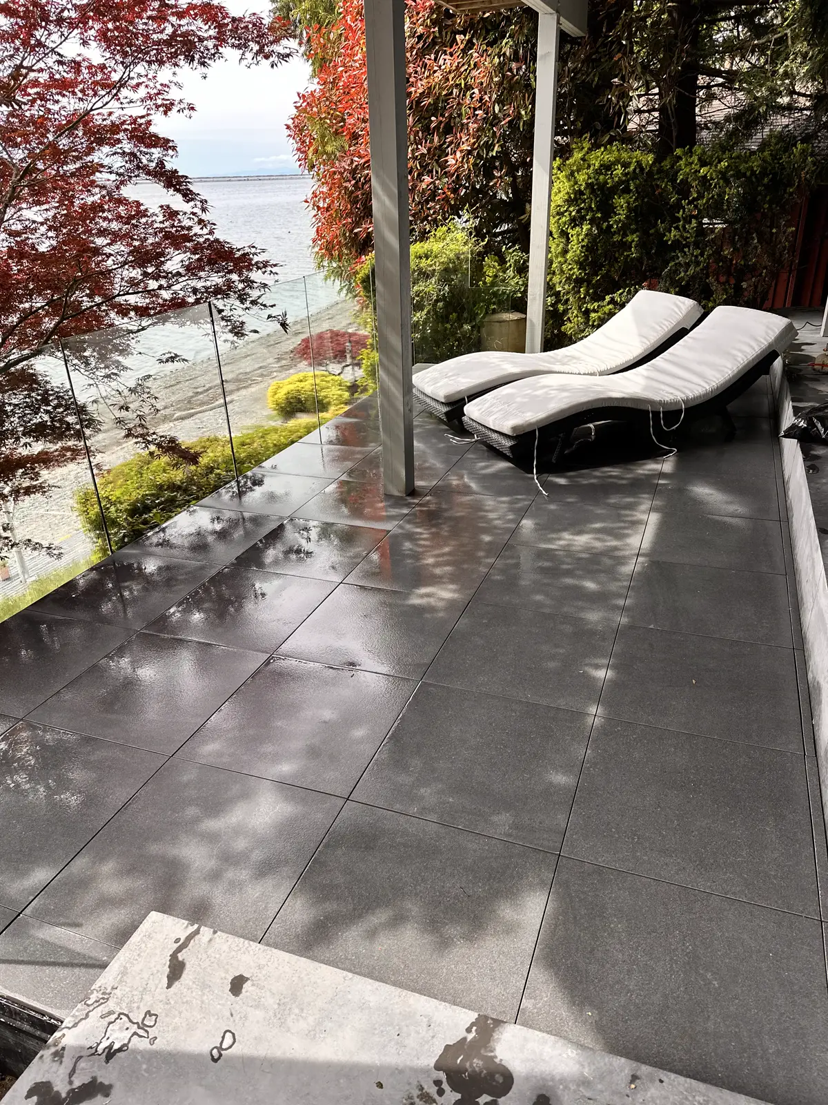 Lakeside deck with infinity-glass railing — Liam Kinders Contracting