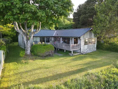 Rear elevation of waterfront cabin with metal roof, Okanagan BC
