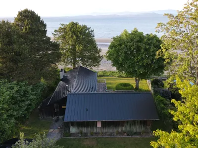 Front elevation of waterfront cabin with new standing-seam metal roof, Okanagan