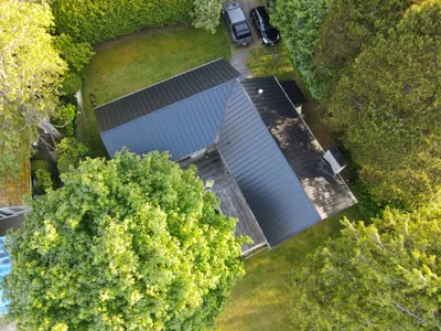 Aerial view of new standing-seam metal roof on a waterfront cabin, Okanagan BC