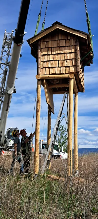 Install crew guiding the bat condo down by hand at Penticton Channel Parkway